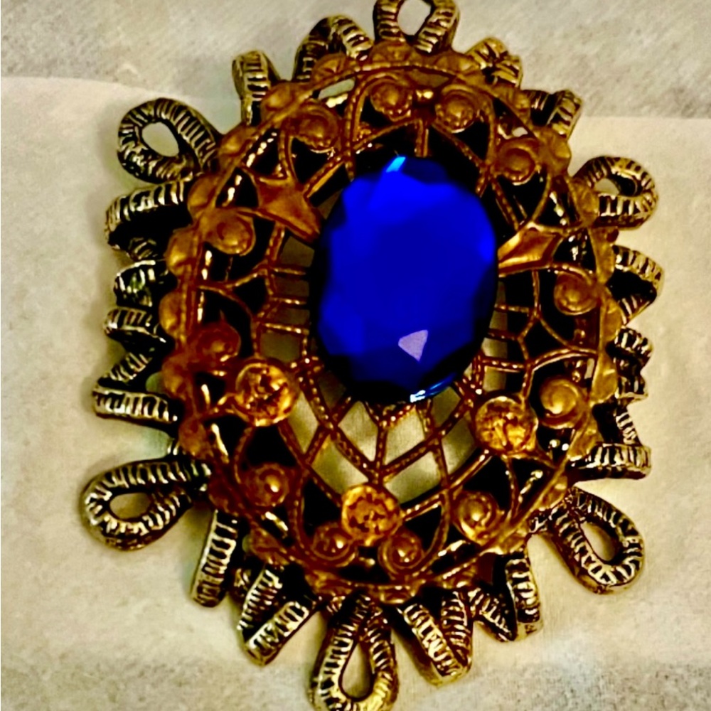 Brooch, gold toned metal, floral design, blue oval faux gemstone element